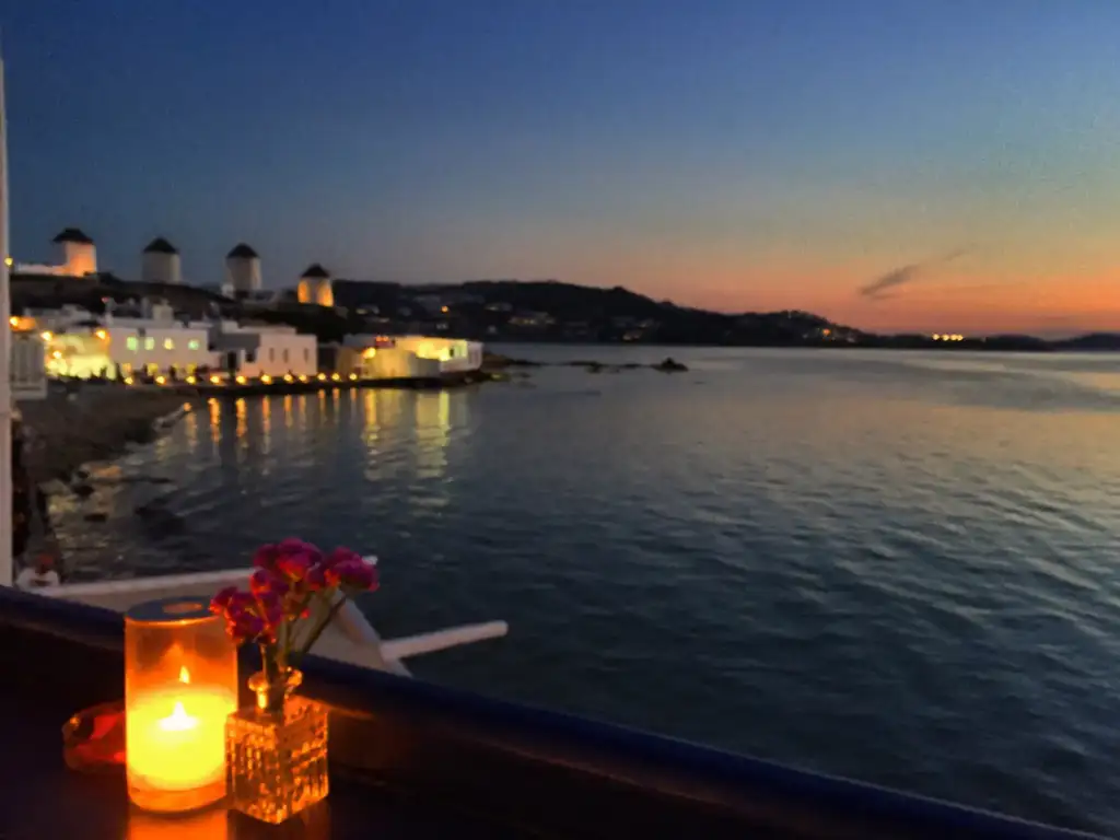 Restaurant in Mykonos with sea view and a candle in sunset